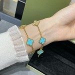 Four-leaf clover gold bracelet with rhinestones and blue accents